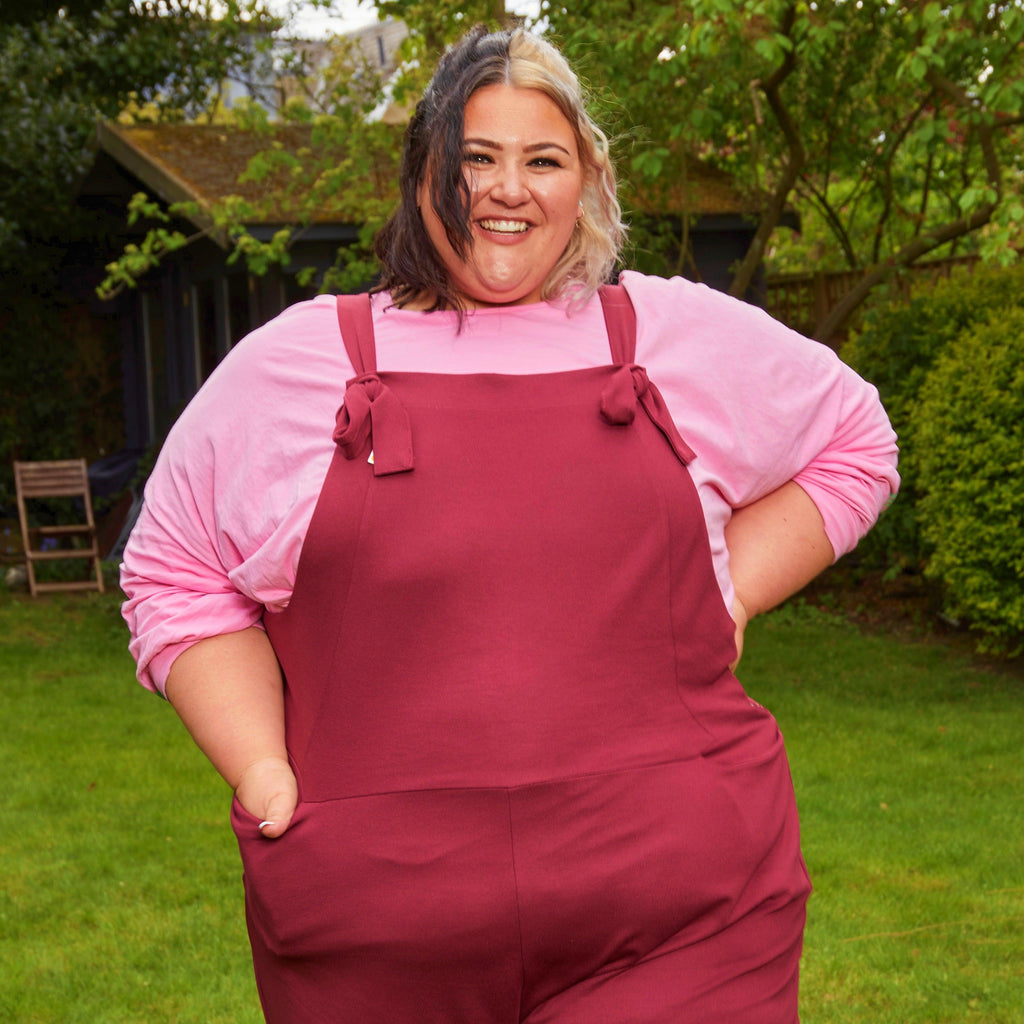 Woman wearing burgundy dungarees