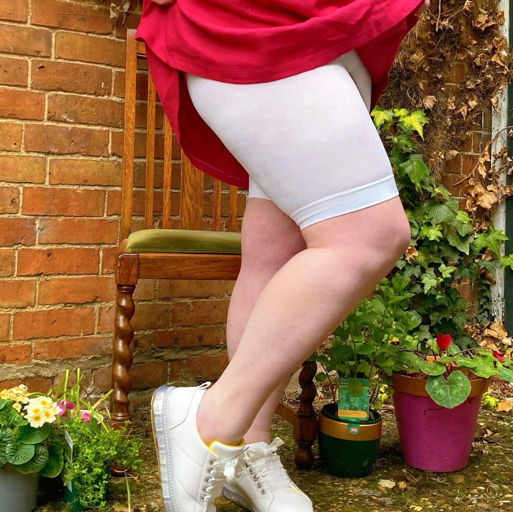 Woman wearing white chub rub shorts